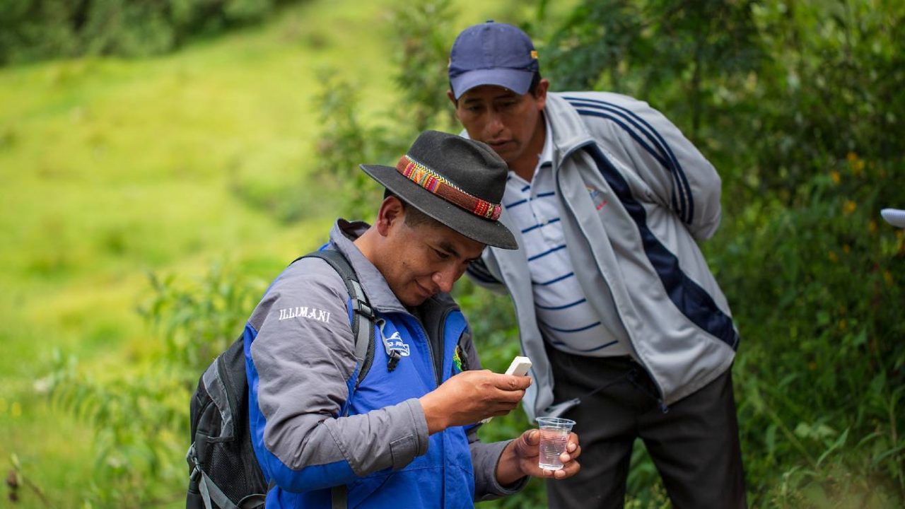Two men examine water samples