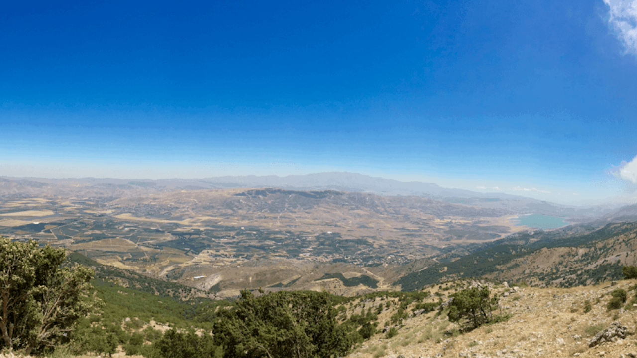High-up view of the landscape and bright blue sky.
