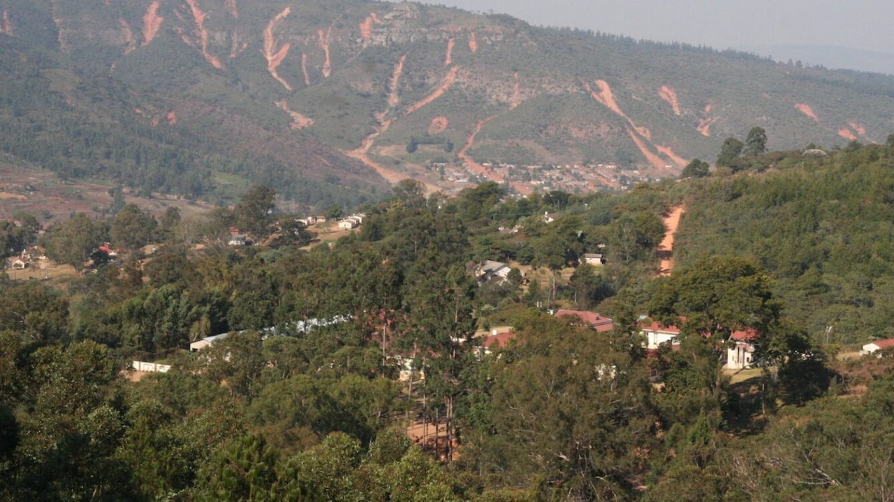 Hills in background, a few houses in foreground.