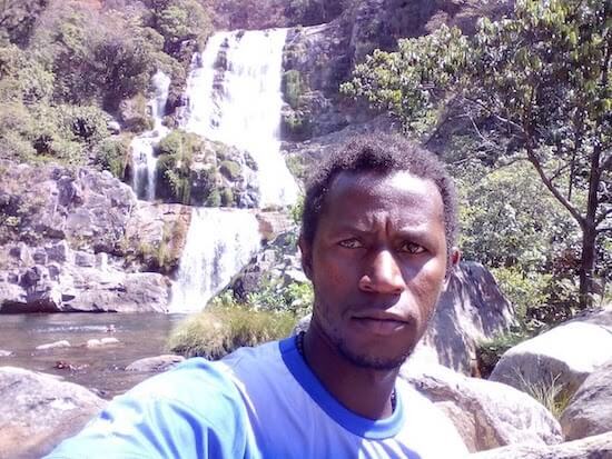 Damiao selfie in front of waterfall.