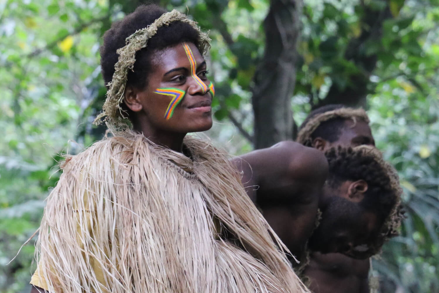 Woman with face painted and in traditional clothing.